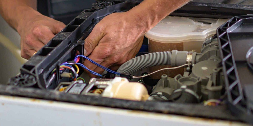 Hands-on work inside a household appliance during repair training